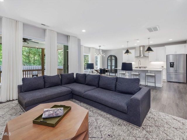 128 Chapel Run Way, Chapel Hill, NC 27517 - living room featuring plenty of natural light, a chandelier, recessed lighting, and wood finished floors