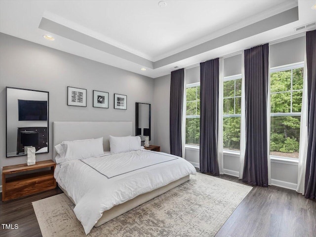 128 Chapel Run Way, Chapel Hill, NC 27517 - bedroom featuring multiple windows, wood finished floors, a tray ceiling, recessed lighting, and ornamental molding