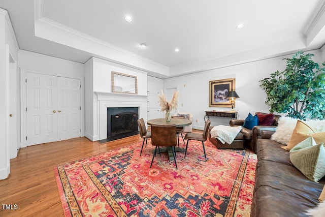 2602 Vintage Hill Ct, Durham, NC 27712 - living area featuring a raised ceiling, light wood-style floors, a fireplace with flush hearth, ornamental molding, and recessed lighting