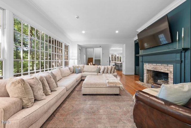 2602 Vintage Hill Ct, Durham, NC 27712 - living area with wood finished floors, a fireplace with flush hearth, ornamental molding, and recessed lighting