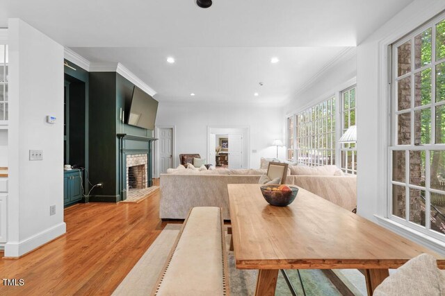 2602 Vintage Hill Ct, Durham, NC 27712 - dining area featuring light wood-type flooring, healthy amount of natural light, recessed lighting, a fireplace, and ornamental molding
