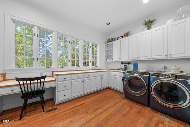 2602 Vintage Hill Ct, Durham, NC 27712 - washroom featuring cabinet space, independent washer and dryer, plenty of natural light, light wood-style flooring, and recessed lighting