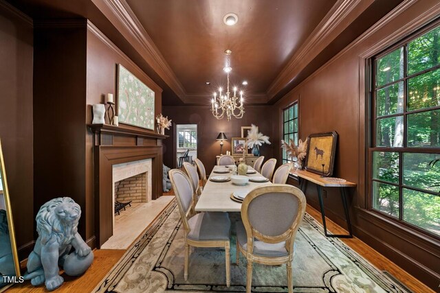 2602 Vintage Hill Ct, Durham, NC 27712 - dining space with wood finished floors, a chandelier, ornamental molding, a fireplace, and a raised ceiling