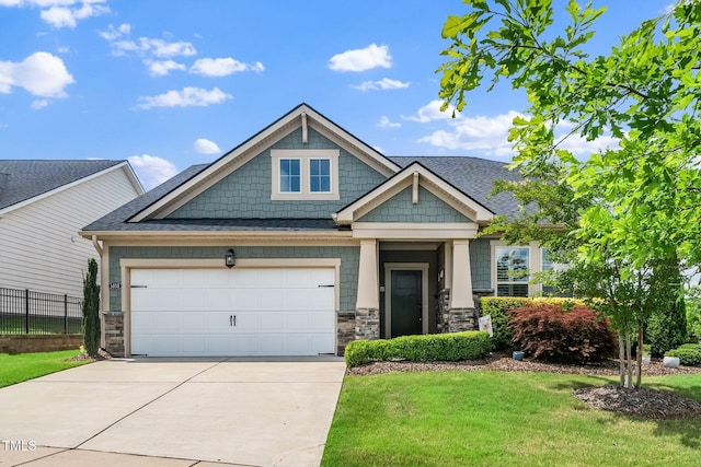 1409 Pulitzer Ln, Durham, NC 27703 - craftsman inspired home featuring concrete driveway, stone siding, an attached garage, and roof with shingles