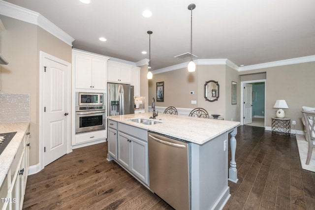1409 Pulitzer Ln, Durham, NC 27703 - kitchen with stainless steel appliances, crown molding, a breakfast bar, dark wood-style flooring, and a center island with sink
