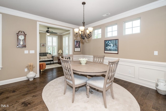 1409 Pulitzer Ln, Durham, NC 27703 - dining space with dark wood-style flooring, ornamental molding, a chandelier, a ceiling fan, and a wainscoted wall