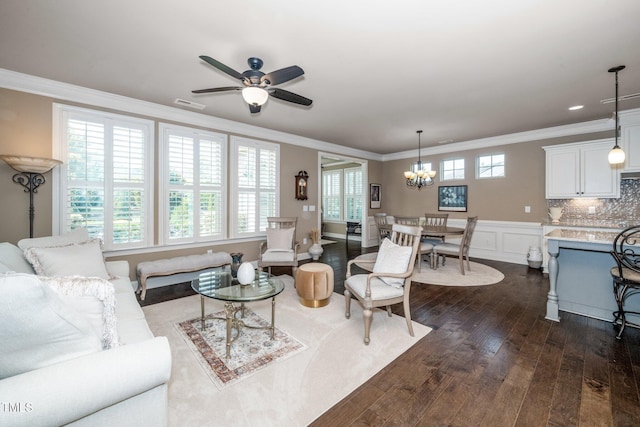 1409 Pulitzer Ln, Durham, NC 27703 - living area featuring ornamental molding, dark wood-style flooring, a chandelier, and ceiling fan
