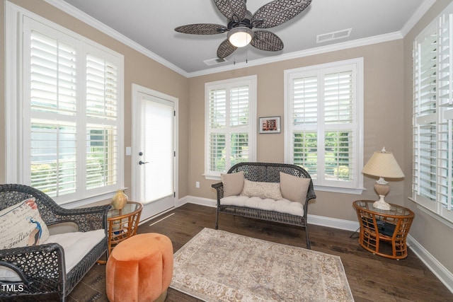 1409 Pulitzer Ln, Durham, NC 27703 - living area featuring wood finished floors, a ceiling fan, ornamental molding, and plenty of natural light