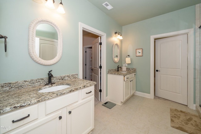 1409 Pulitzer Ln, Durham, NC 27703 - bathroom featuring two vanities, a shower stall, and tile patterned flooring