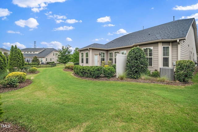 1409 Pulitzer Ln, Durham, NC 27703 - rear view of house featuring roof with shingles