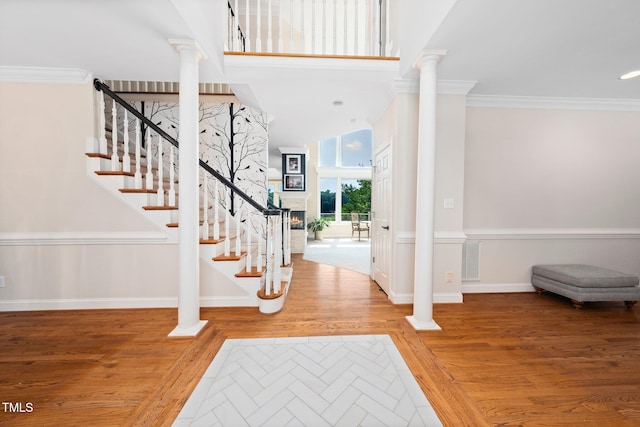 115 Loch Vale Ln, Cary, NC 27518 - foyer entrance with ornate columns, stairs, crown molding, and wood finished floors