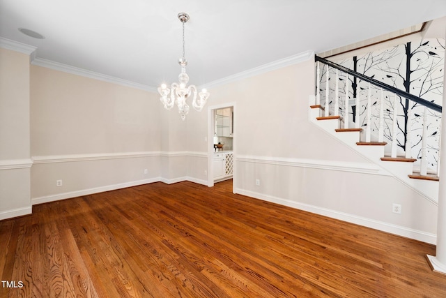 115 Loch Vale Ln, Cary, NC 27518 - unfurnished dining area featuring ornamental molding, a chandelier, wood finished floors, and stairs