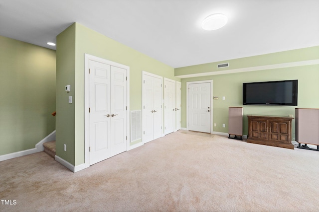 115 Loch Vale Ln, Cary, NC 27518 - unfurnished living room with carpet flooring and stairs