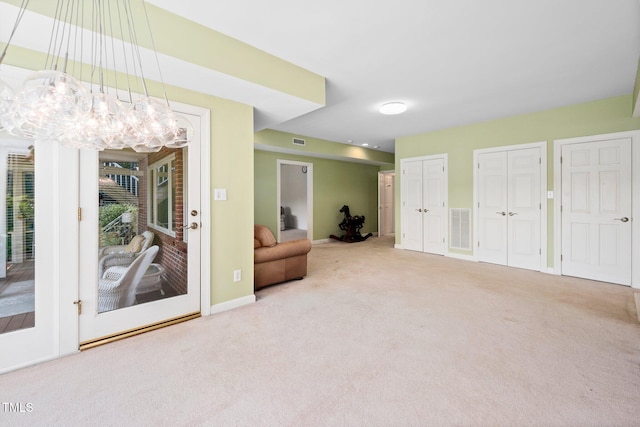 115 Loch Vale Ln, Cary, NC 27518 - living area featuring carpet flooring and a chandelier