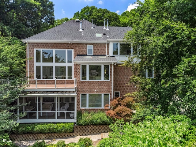 115 Loch Vale Ln, Cary, NC 27518 - back of house featuring a sunroom, brick siding, and a shingled roof
