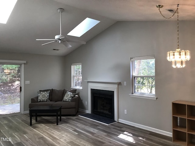 303 Saint Thomas Dr, Chapel Hill, NC 27517 - living room featuring a skylight, dark wood finished floors, a fireplace, a ceiling fan, and high vaulted ceiling
