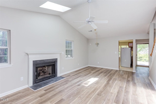 303 Saint Thomas Dr, Chapel Hill, NC 27517 - unfurnished living room featuring a fireplace, a skylight, light wood finished floors, ceiling fan, and high vaulted ceiling