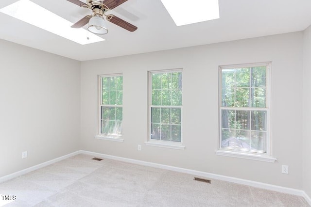 303 Saint Thomas Dr, Chapel Hill, NC 27517 - spare room featuring a skylight, light carpet, and healthy amount of natural light