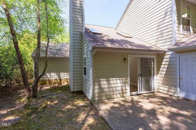 303 Saint Thomas Dr, Chapel Hill, NC 27517 - view of home's exterior featuring a shingled roof and a chimney