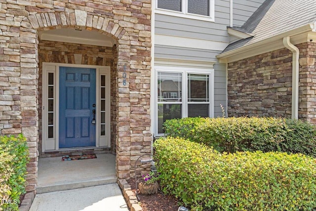 108 Holly Glen Ct, Holly Springs, NC 27540 - view of exterior entry featuring stone siding and roof with shingles
