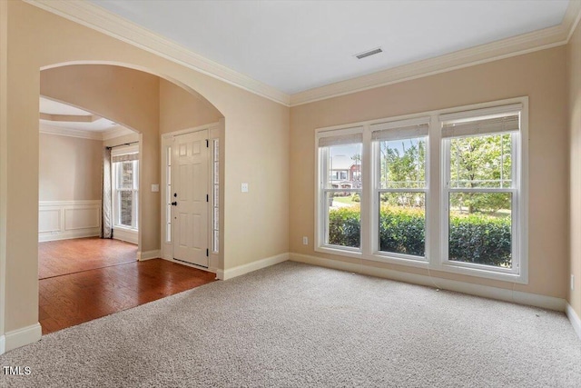 108 Holly Glen Ct, Holly Springs, NC 27540 - empty room featuring carpet, arched walkways, healthy amount of natural light, and ornamental molding