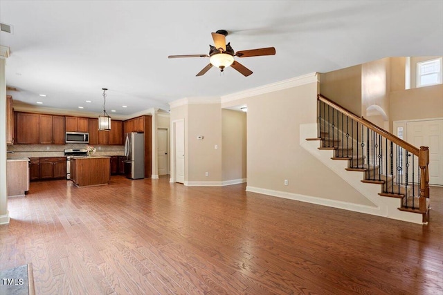 108 Holly Glen Ct, Holly Springs, NC 27540 - unfurnished living room featuring a ceiling fan, wood finished floors, stairway, recessed lighting, and ornamental molding