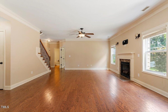 108 Holly Glen Ct, Holly Springs, NC 27540 - unfurnished living room featuring stairway, a premium fireplace, ceiling fan, wood finished floors, and ornamental molding