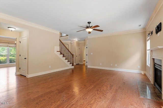 108 Holly Glen Ct, Holly Springs, NC 27540 - unfurnished living room featuring stairway, a premium fireplace, a ceiling fan, wood finished floors, and crown molding