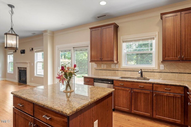 108 Holly Glen Ct, Holly Springs, NC 27540 - kitchen featuring a center island, light stone counters, tasteful backsplash, light wood-type flooring, and stainless steel dishwasher