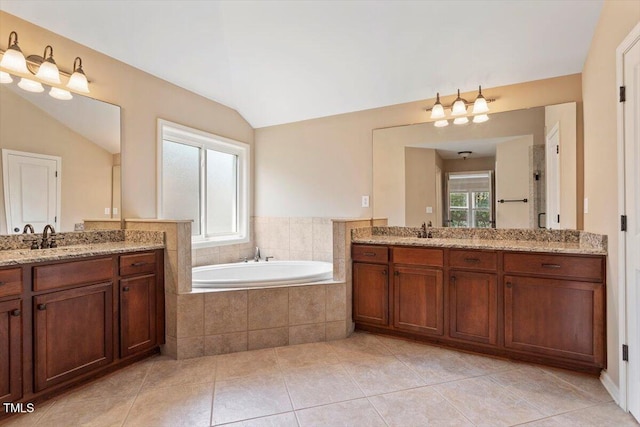 108 Holly Glen Ct, Holly Springs, NC 27540 - bathroom featuring two vanities, a bath, tile patterned floors, and vaulted ceiling