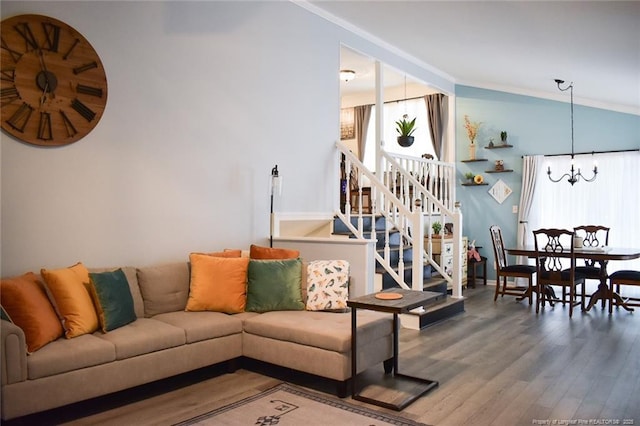 133 Bonnell Ct, Cary, NC 27511 - living room featuring a chandelier, wood finished floors, crown molding, lofted ceiling, and stairs