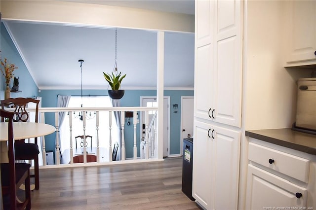 133 Bonnell Ct, Cary, NC 27511 - kitchen featuring crown molding, white cabinets, wood finished floors, and dark countertops