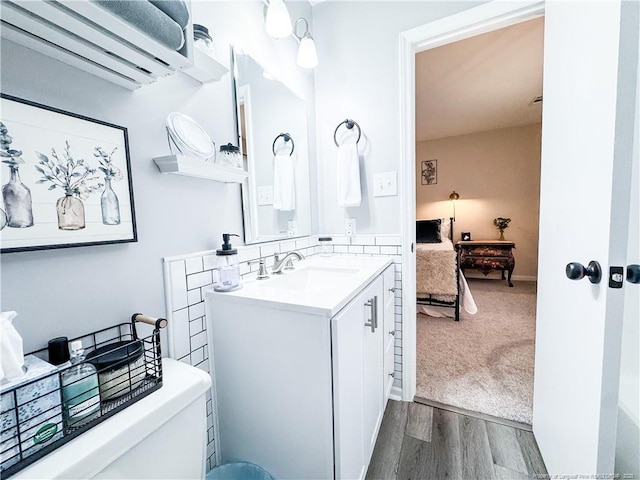 133 Bonnell Ct, Cary, NC 27511 - ensuite bathroom with a wall unit AC, vanity, and wood finished floors