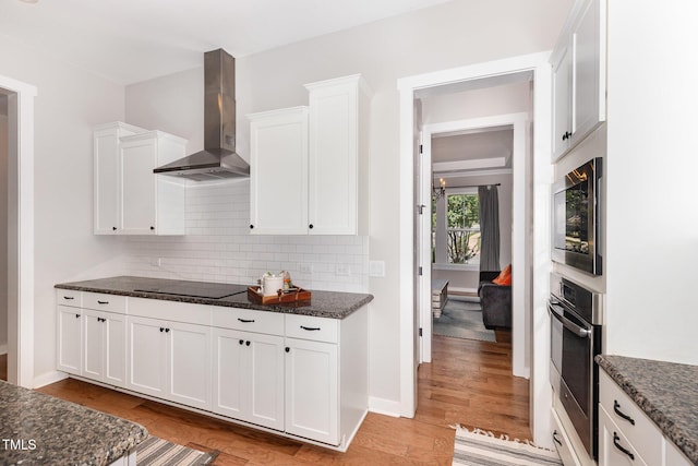 1502 Spring Overlook Ln, Hillsborough, NC 27278 - kitchen with wall chimney exhaust hood, appliances with stainless steel finishes, white cabinets, tasteful backsplash, and dark stone countertops