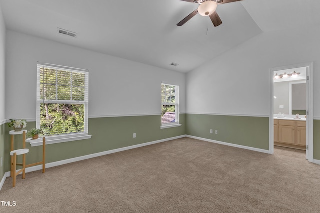 11309 Shadow Elms Ln, Raleigh, NC 27614 - spare room featuring vaulted ceiling, a ceiling fan, and light carpet