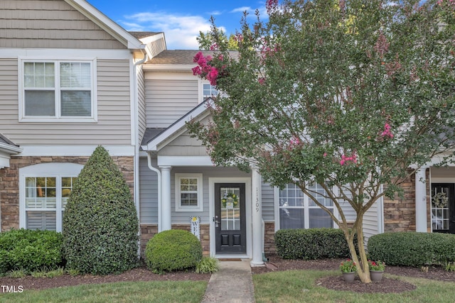 11309 Shadow Elms Ln, Raleigh, NC 27614 - view of front facade featuring stone siding and a shingled roof