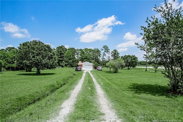 11821 N NC Highway 41, Lumberton, NC 28358 - view of green lawn with dirt driveway and a garage