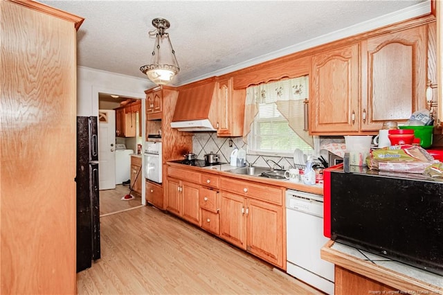 11821 N NC Highway 41, Lumberton, NC 28358 - kitchen featuring black appliances, premium range hood, washer / clothes dryer, light wood finished floors, and decorative backsplash
