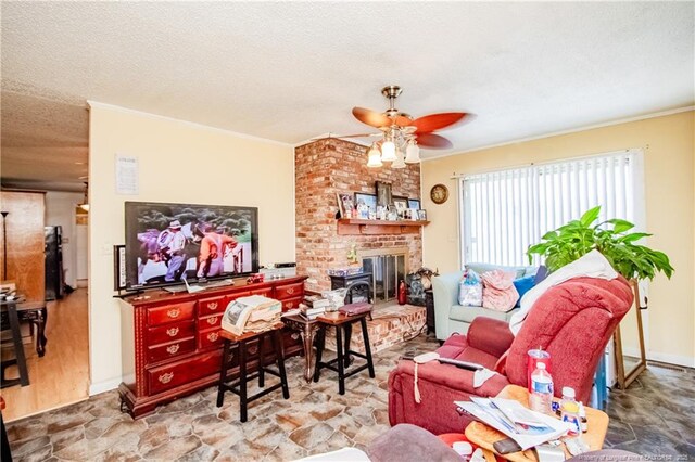 11821 N NC Highway 41, Lumberton, NC 28358 - living area featuring a ceiling fan, ornamental molding, a textured ceiling, stone finish floors, and a brick fireplace