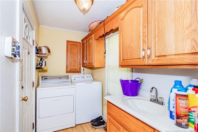 11821 N NC Highway 41, Lumberton, NC 28358 - washroom featuring washer and dryer, cabinet space, ornamental molding, and light wood-style flooring