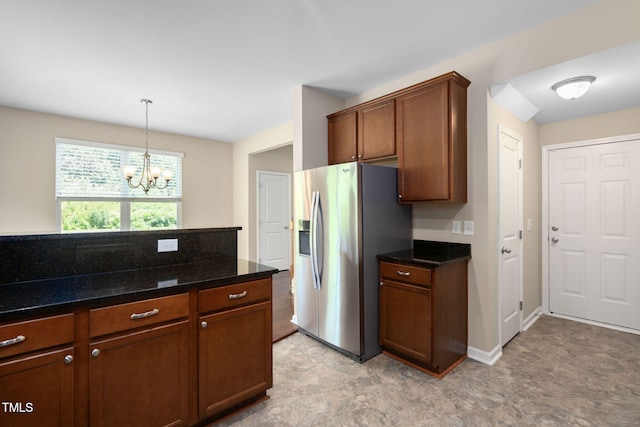 3417 Cardinal Lake Dr, Durham, NC 27704 - kitchen with stainless steel fridge with ice dispenser, a chandelier, dark stone countertops, decorative light fixtures, and brown cabinetry