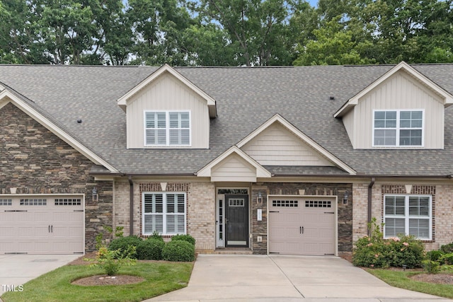 2022 Chandler Village Dr, Graham, NC 27253 - view of front of house with concrete driveway, a garage, stone siding, and roof with shingles