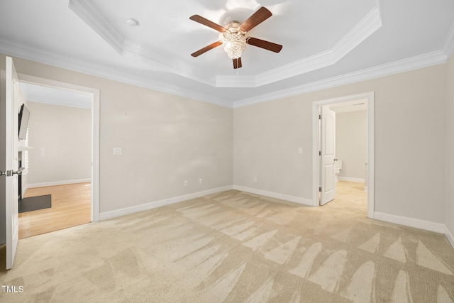 2022 Chandler Village Dr, Graham, NC 27253 - empty room featuring a tray ceiling, light carpet, ornamental molding, and a ceiling fan