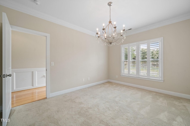 2022 Chandler Village Dr, Graham, NC 27253 - carpeted spare room featuring ornamental molding, a chandelier, and a smoke detector