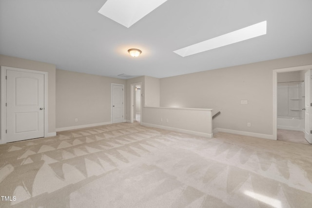 2022 Chandler Village Dr, Graham, NC 27253 - carpeted spare room featuring a skylight and baseboards