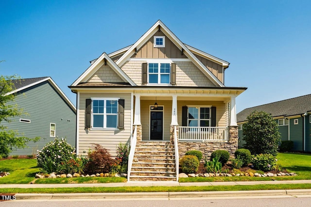 262 Salt Cedar Ln, Chapel Hill, NC 27516 - craftsman-style home with stairs, a porch, board and batten siding, and stone siding