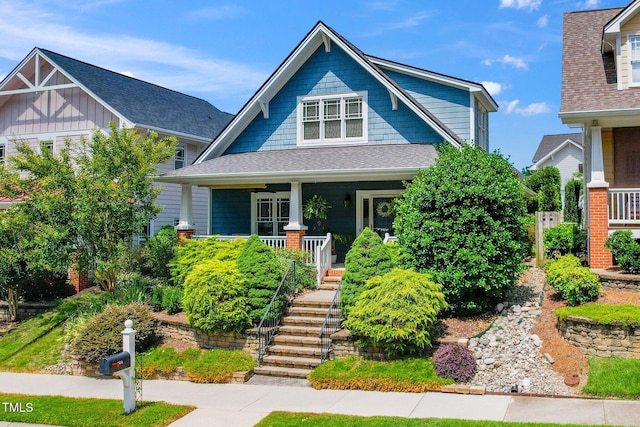104 Homegate Cir, Apex, NC 27502 - craftsman-style house featuring a porch, stairway, and roof with shingles