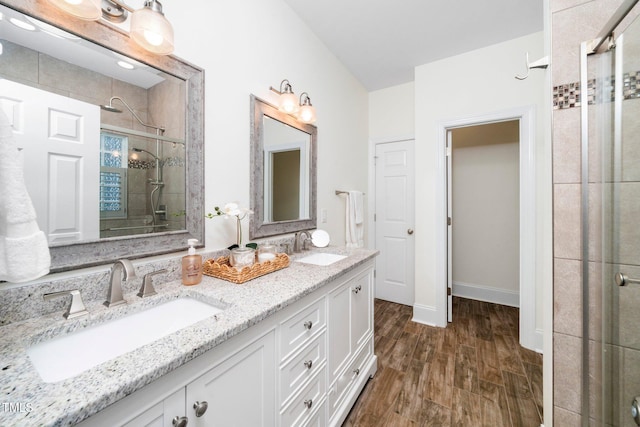 104 Homegate Cir, Apex, NC 27502 - bathroom featuring a stall shower, double vanity, and wood finished floors