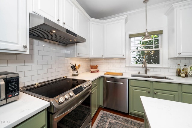 104 Homegate Cir, Apex, NC 27502 - kitchen featuring green cabinets, appliances with stainless steel finishes, under cabinet range hood, light countertops, and crown molding