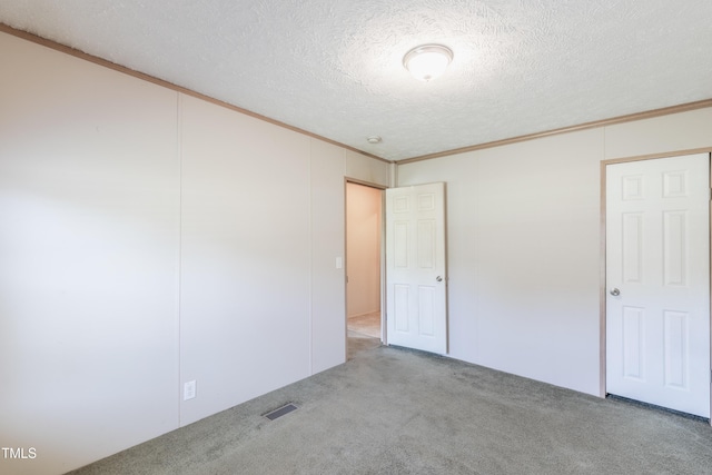 451 Rawls Rd, Aulander, NC 27805 - unfurnished bedroom with crown molding, carpet flooring, and a textured ceiling
